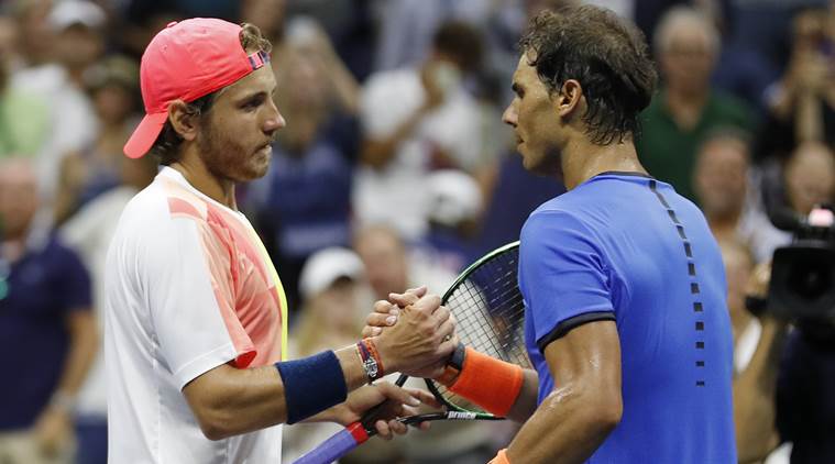 Lucas Pouille, of France, shakes hands with Rafael Nadal, of Spain, after winning their match during the fourth round of the U.S. Open tennis tournament, Sunday, Sept. 4, 2016, in New York. (AP Photo/Alex Brandon)