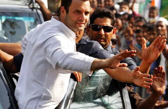 Rahul Gandhi (L), India's ruling Congress party vice president and son of Congress chief Sonia Gandhi, waves to his supporters during a road show ahead of the 2014 general elections at Samuguri village in the northeastern Indian state of Assam February 26, 2014. REUTERS/Utpal Baruah (INDIA - Tags: POLITICS ELECTIONS) - RTR3FQNC