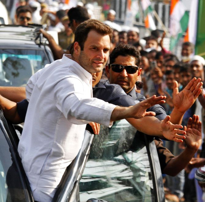 Rahul Gandhi (L), India's ruling Congress party vice president and son of Congress chief Sonia Gandhi, waves to his supporters during a road show ahead of the 2014 general elections at Samuguri village in the northeastern Indian state of Assam February 26, 2014. REUTERS/Utpal Baruah (INDIA - Tags: POLITICS ELECTIONS) - RTR3FQNC